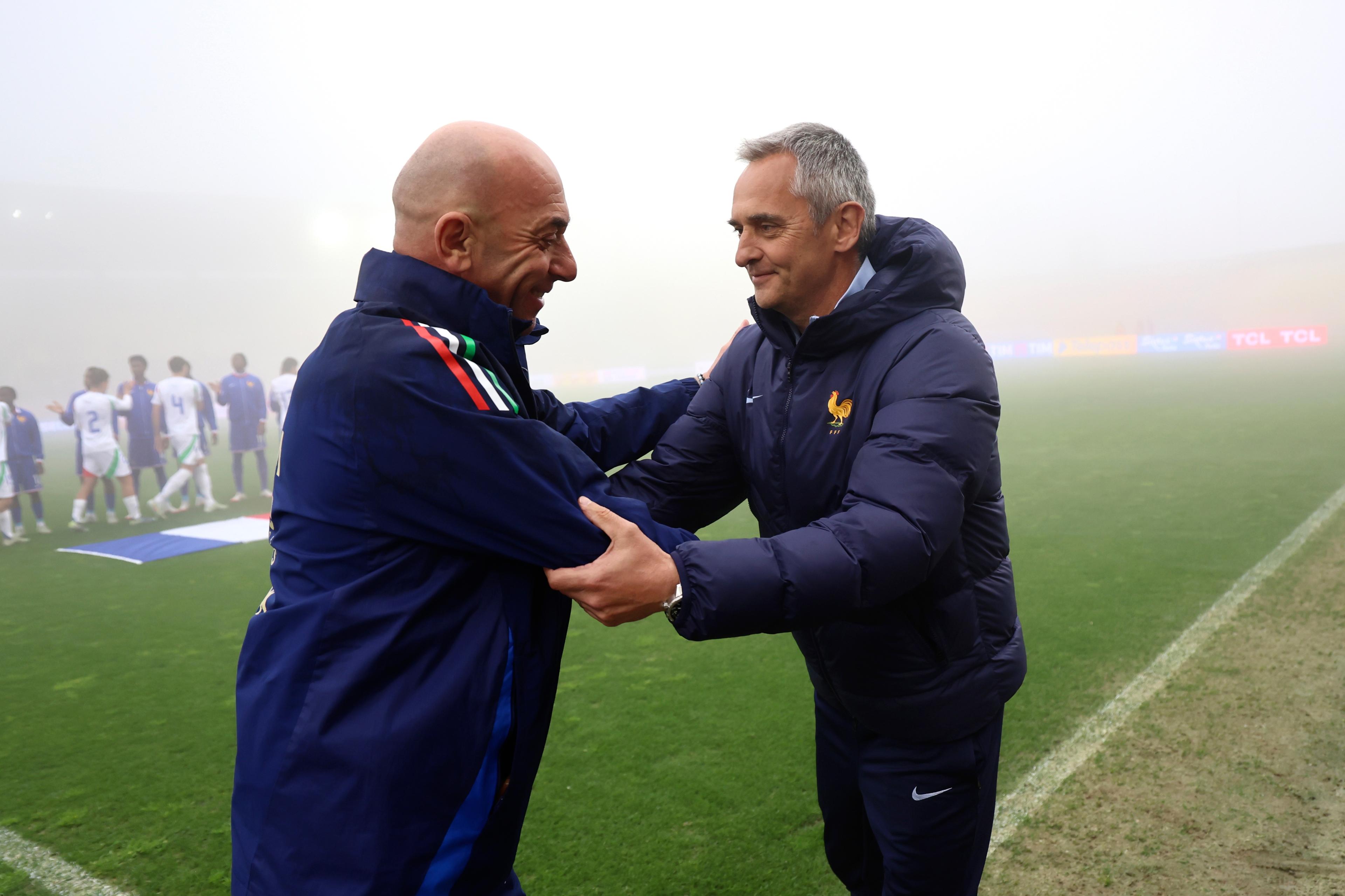 CATANZARO, ITALY - MARCH 25: Head coach of Italy U19 Alberto Bollini salutes head coach of France U19 Jean Luc Vannuchi prior the Elite Round match between Italy U19 and France U19 at Stadio Nicola Ceravolo on March 25, 2025 in Catanzaro, Italy. (Photo by FIGC/FIGC via Getty Images)