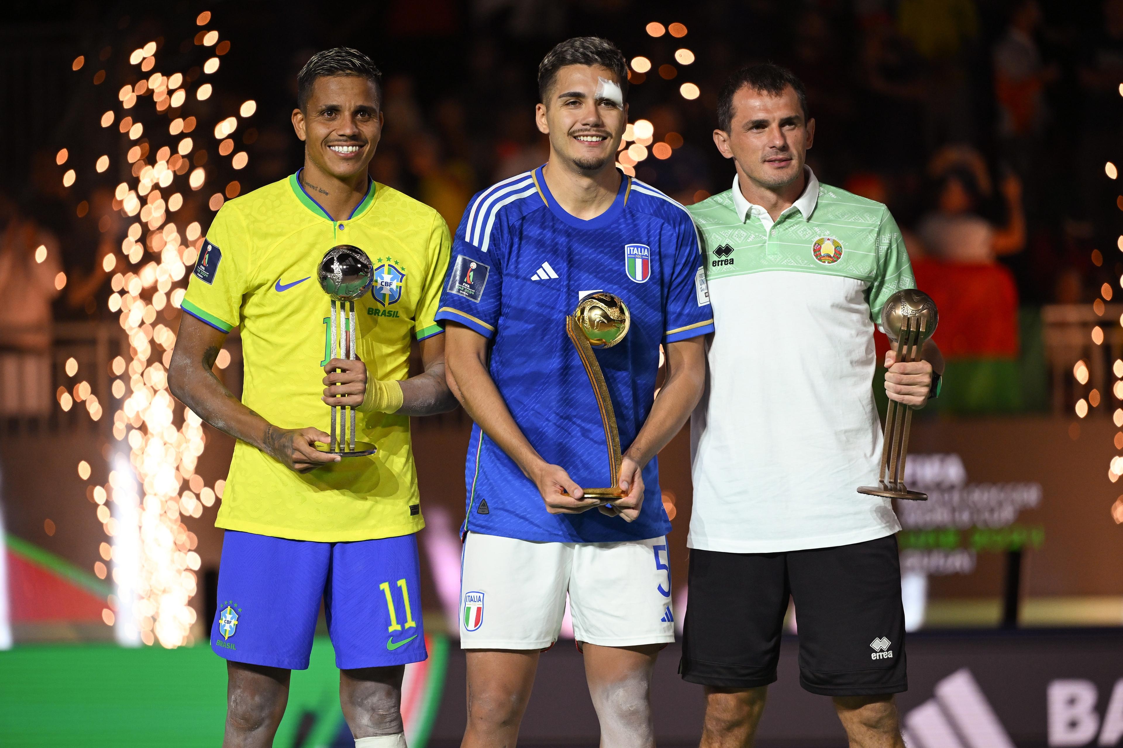 DUBAI, UNITED ARAB EMIRATES - FEBRUARY 25: (L-R) Mauricinho of Brazil, Josep Junior Gentilin of Italy and Yahor Hardzetski of Belarus pose for a photo with the adidas golden ball during the FIFA Beach Soccer World Cup UAE 2024 Final match between Brazil and Italy at Dubai Design District Stadium on February 25, 2024 in Dubai, United Arab Emirates. (Photo by Tullio Puglia - FIFA/FIFA via Getty Images)