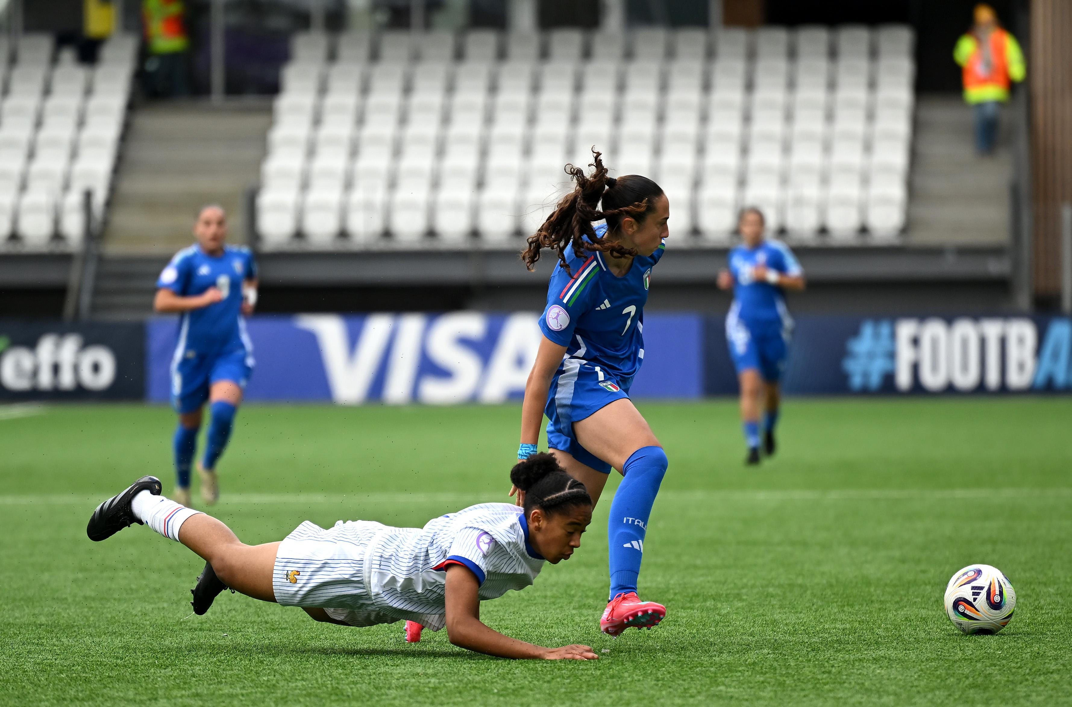 TORSHAVN, FAEROE ISLANDS - MAY 08: Medina Belaid of France goes down as she battles for possession with Giulia Galli of Italy during the UEFA Women's European Under-17 Championship Group Stage match between Italy and France at Torsvollur on May 08, 2025 in Torshavn, Faeroe Islands. (Photo by Shauna Clinton/UEFA via Getty Images)