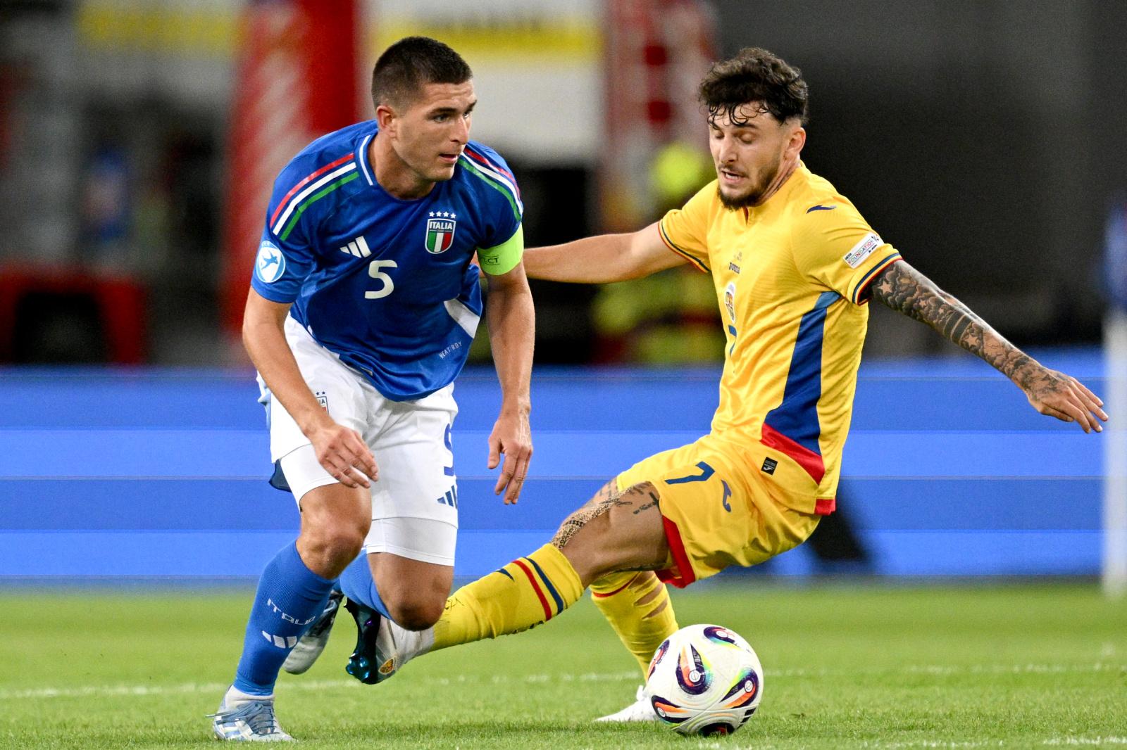 TRNAVA, SLOVAKIA - JUNE 11: Lorenzo Pirola of Italy being followed by Ianis Stoica of Romania during the UEFA European Under-21 Championship 2025 Group Stage match between Italy and Romania at A. Malatinsky Stadium on June 11, 2025 in Trnava, Slovakia. (Photo by Tullio Puglia - UEFA/UEFA via Getty Images)